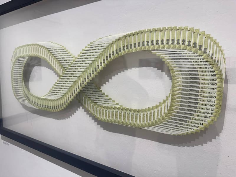 Art installation made from Indian rupee notes in infinity symbol